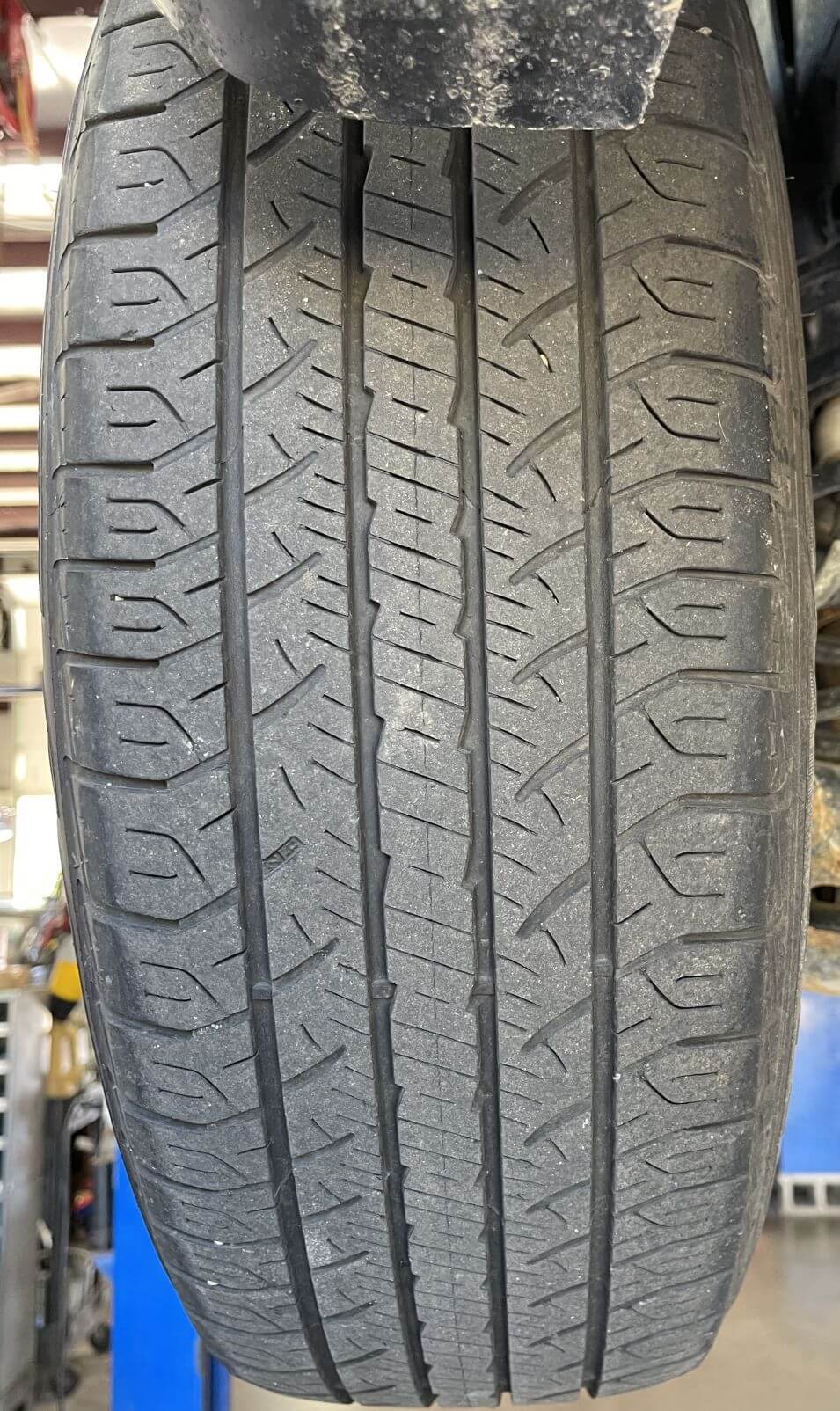Checking tire tread depth before winter at Carz R Us auto repair in Machesney Park IL